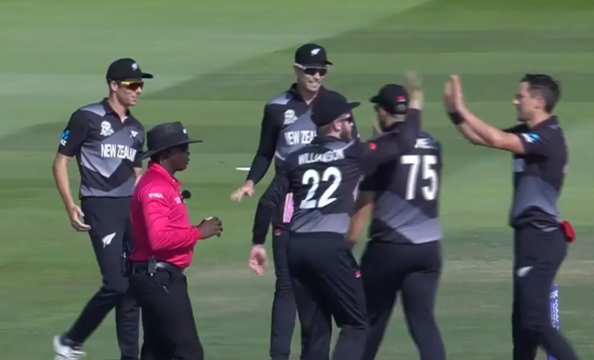 New Zealand players celebrating the fall of a wicket. 