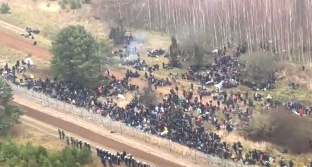 Hundreds of migrants are seen on the Belarus side of the border with Poland, guarded by the Polish soldiers near Kuznica Bialostocka, Poland, in this video-grab released by the Polish Defence Ministry, November 8, 2021.