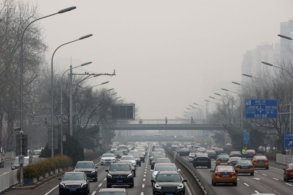 Cars drive in the city centre, on the day of closing session of the Chinese People's Political Consultative Conference (CPPCC), during a polluted day in Beijing, China, March 10, 2021. REUTERS/Thomas Peter/File Photo