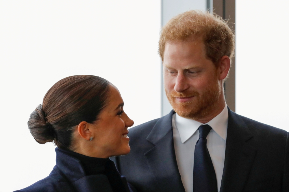 File photo: Britain's Prince Harry and Meghan look at each other during a visit to One World Trade Center in Manhattan, New York City, US, September 23, 2021. Reuters/Andrew Kelly/File Photo