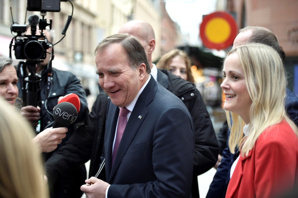 Swedish Prime Minister Stefan Lofven interacts with journalists as he walks from the government headquarters to the Swedish Parliament Riksdagen to hand in his resignation to the speaker of parliament in Stockholm, Sweden November 10, 2021. Duygu Getrien/TT News Agency