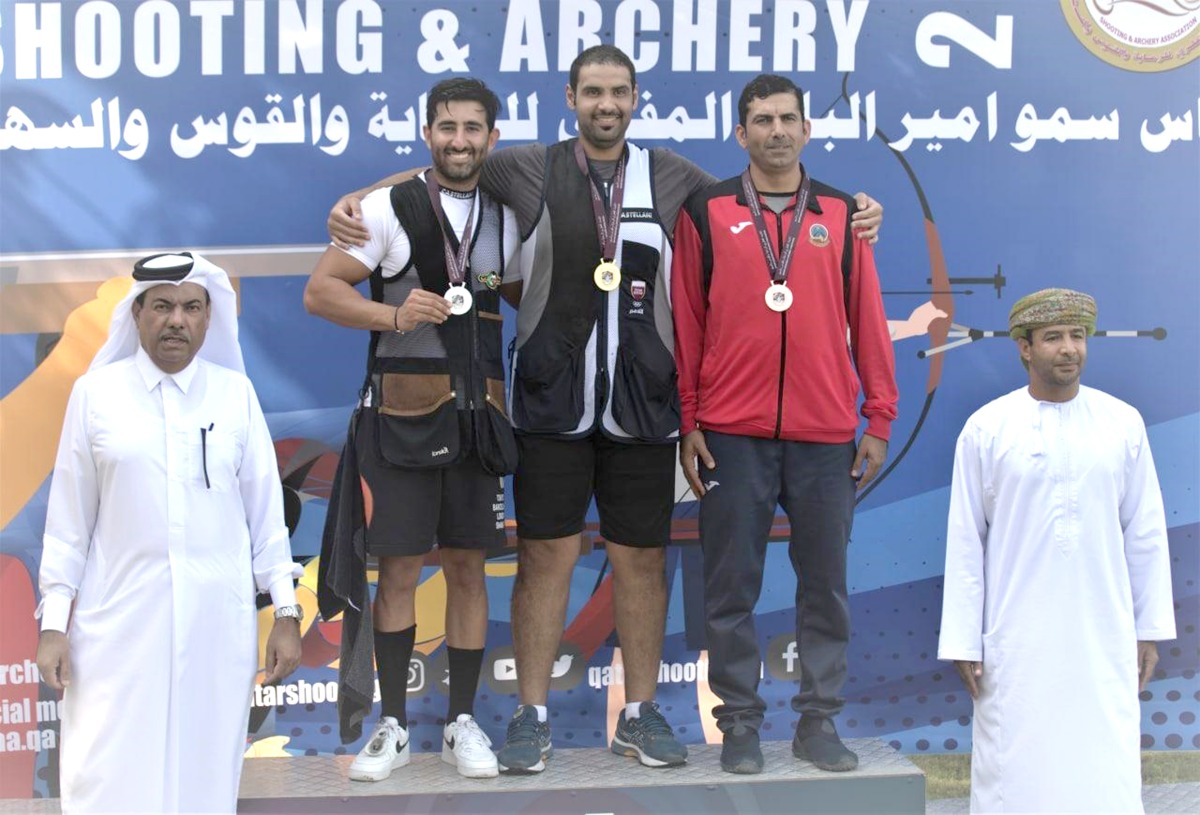 Mohamed Al Rumaihi (centre) and other podium finishers pose with the officials after the medals presentation ceremony at the Lusail Shooting Complex, yesterday. 