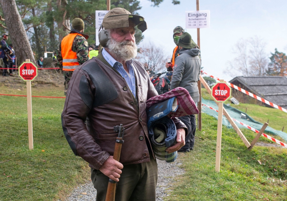 85-year-old Toni Hacki of the Ruetlischuetzengesellschaft Engelberg shooter association stands with his old Karabiner 31 infantry rifle at the Ruetli meadow in central Switzerland November 10, 2021. Reuters/Arnd Wiegmann
 