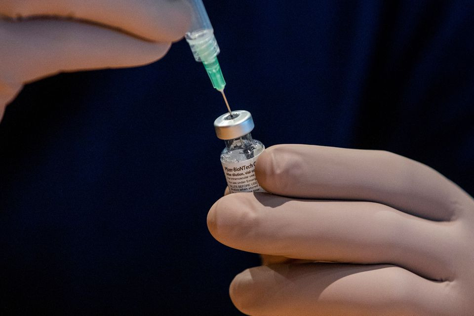 A healthcare worker prepares a dose of the Pfizer/BioNTech coronavirus disease (COVID-19) vaccine, which was authorized by Canada to be used for children aged 12 to 15, at Woodbine Racetrack pop-up vaccine clinic in Toronto, Ontario, Canada May 5, 2021. REUTERS/Carlos Osorio

