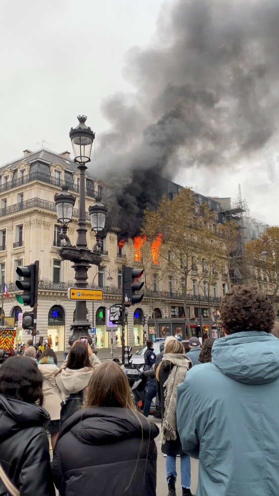 Fire and smoke come out of a building near Place de l'Opera in Paris, France, November 20, 2021 in this still image obtained from a social media video. @alex_grandremy/via REUTERS 