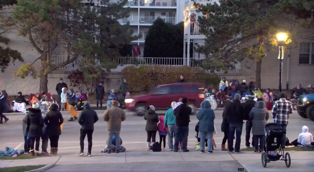 A red SUV speeds past attendees moments before plowing into a crowd at a Christmas parade in Waukesha, Wisconsin, U.S., in this still image taken from a November 21, 2021 social media video. CITY OF WAUKESHA/Facebook/via REUTERS