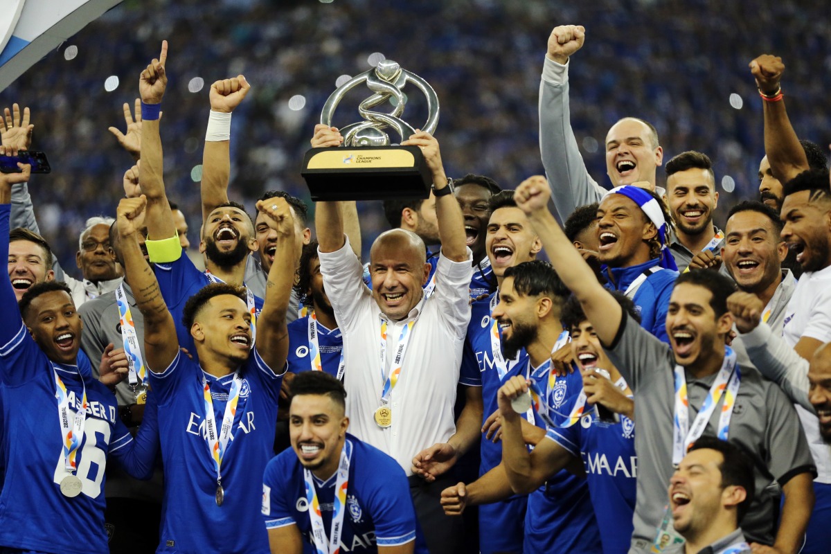 Al Hilal coach Leonardo Jardim celebrates with the trophy and his players after winning the Asian Champions League (ACL) final against Pohang Steelers at King Fahd International Stadium in Riyadh, Saudia Arabia, yesterday. Al Hilal claimed a record fourth ACL title after they beat the South Korean club 2-0.