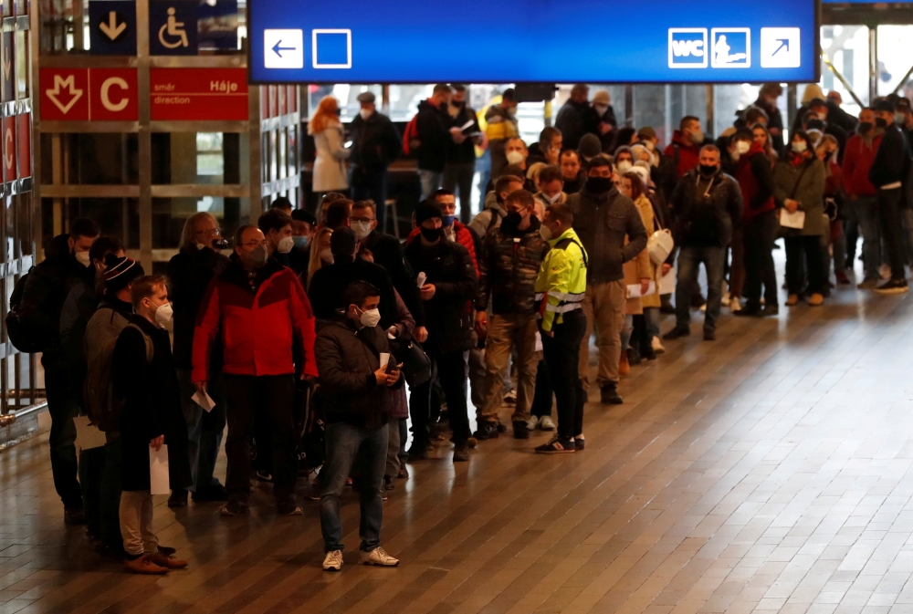 People wait in a line to get the coronavirus disease (COVID-19) vaccine at Prague's main railway station, Czech Republic, November 22, 2021. REUTERS/David W Cerny/File Photo