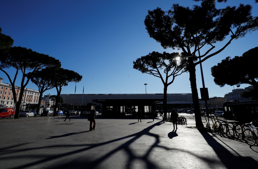 People walk at Termini train station, as the government discusses more stringent rules for the coronavirus disease (COVID-19) health pass known as a Green Pass, in Rome, Italy November 24, 2021. REUTERS/Yara Nardi