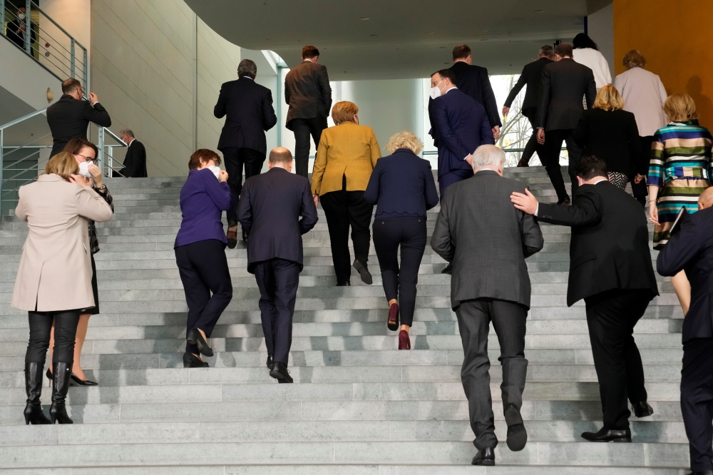 Acting German Chancellor Angela Merkel leaves, along with members of her government, after posing for a group photo after the weekly cabinet meeting at the Chancellery in Berlin, Germany, November 24, 2021. Markus Schreiber/Pool via REUTERS