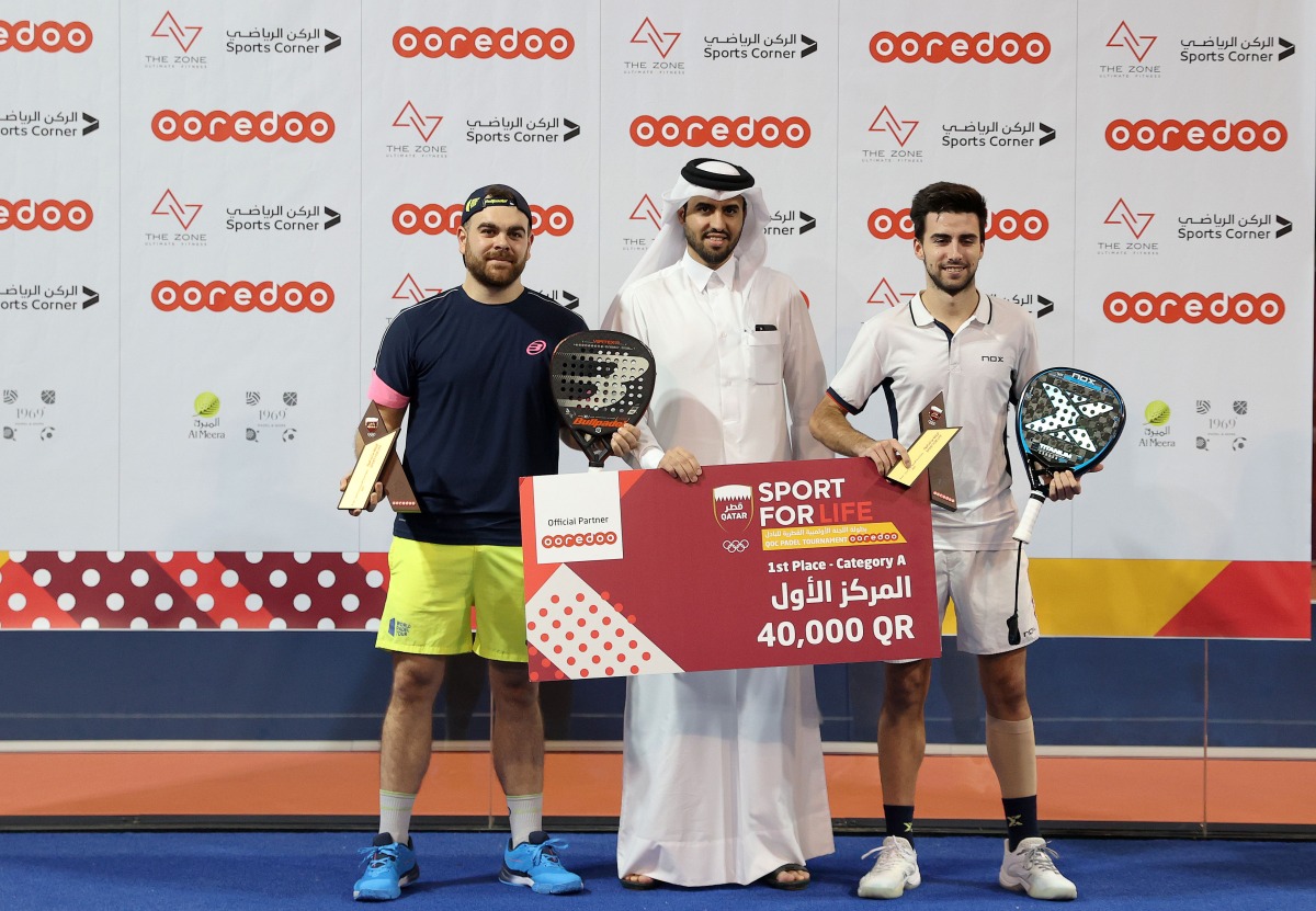 Men's Category A winners of the QOC Padel Tournament 2021 by Ooredoo, Carlos Lopez Hidalgo and Gonzalo Sacho with Thani Al Malki, Executive Director, Business at Ooredoo, during the presentation ceremony. 