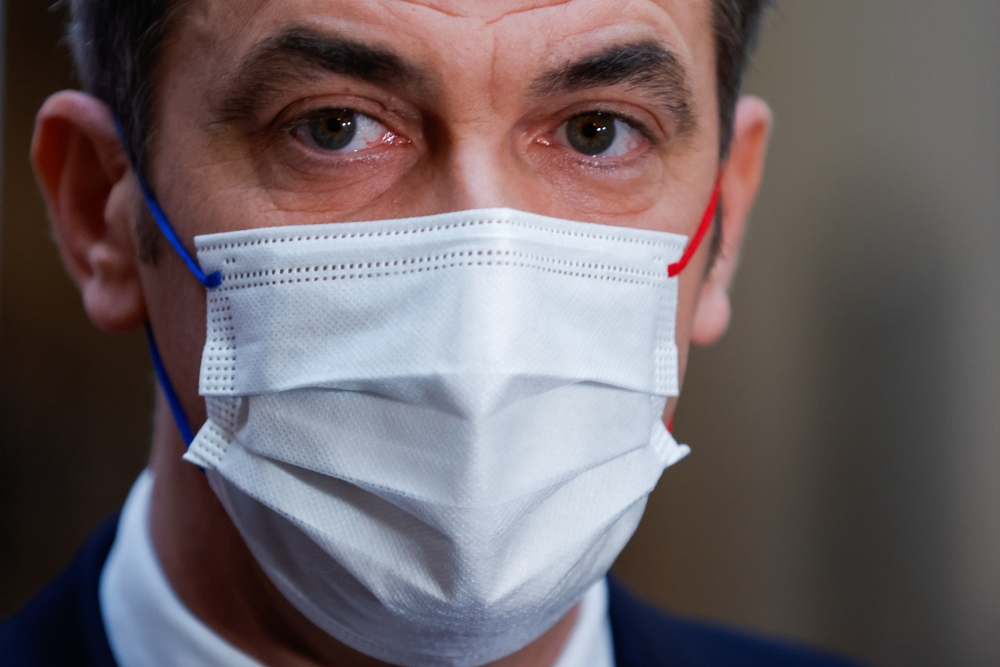French Health Minister Olivier Veran talks to journalists after his visit to a coronavirus disease (COVID-19) vaccination center in Paris, France, November 28, 2021. REUTERS/Gonzalo Fuentes