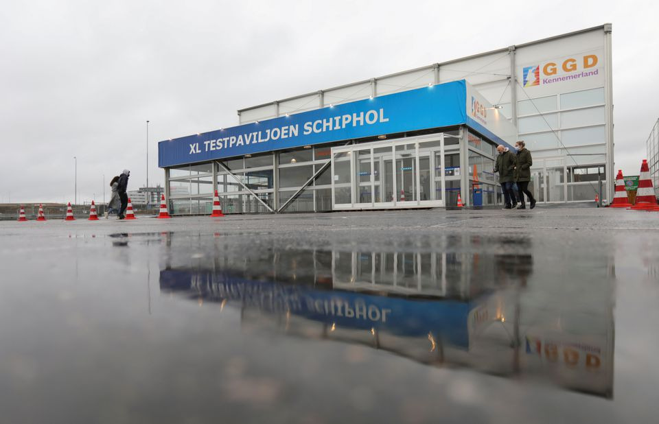 People walk outside XL Schiphol test pavilion after Dutch health authorities said that 61 people who arrived in Amsterdam on flights from South Africa tested positive for COVID-19, in Amsterdam, Netherlands, November 27, 2021. REUTERS/Eva Plevier

