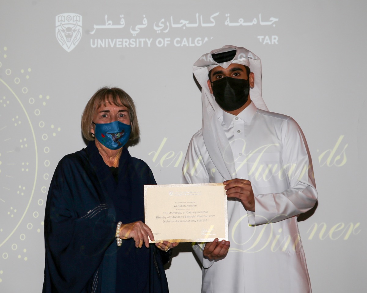 UCQ Dean and Professor, Dr. Deborah White, handing over an outstanding award to a student during the annual awards ceremony. 