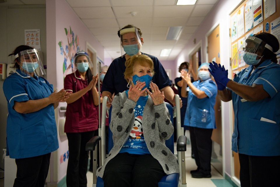 Margaret Keenan, 90, is applauded by staff as she returns to her ward after becoming the first person in Britain to receive the Pfizer/BioNTech COVID-19 vaccine at University Hospital, at the start of the largest ever immunisation programme in the British history, in Coventry, Britain December 8, 2020. Jacob King/Pool via REUTERS

