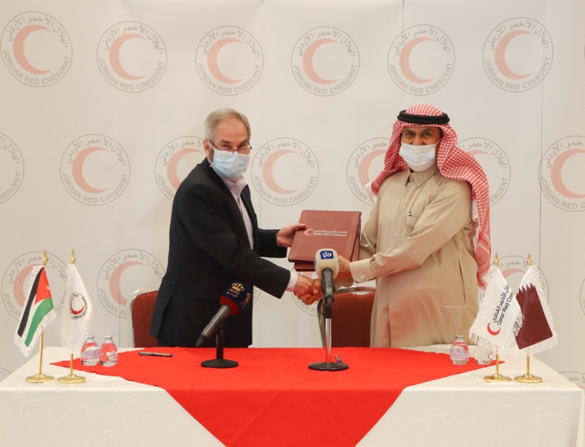 Secretary-General of QRCS Ali bin Hassan Al Hammadi and Vice-President of JNRCS Eng. Omar Abu-Goura exchanging documents after signing the agreement.
