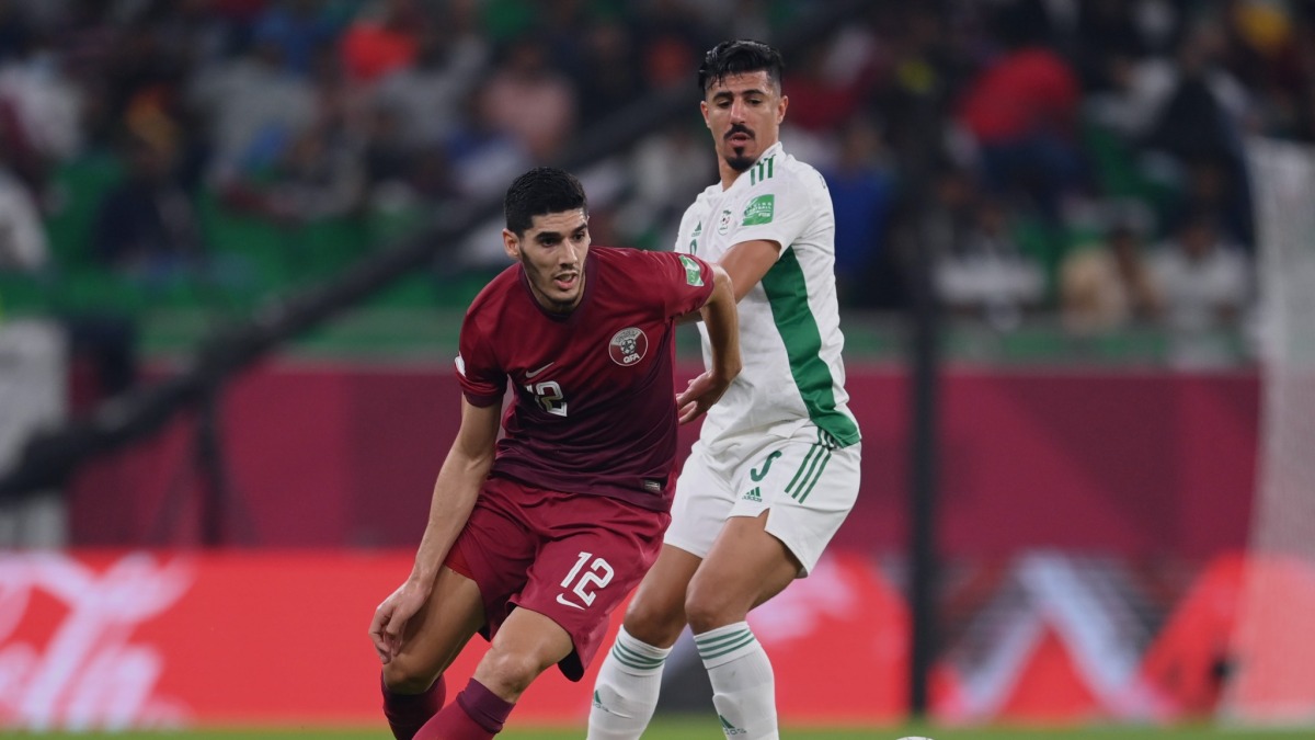 Karim Boudiaf vies for the ball possession with Baghdad Bounedjah of Algeria.
