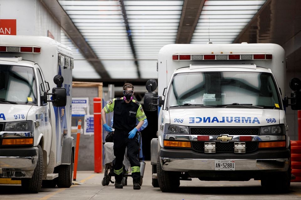 Ambulance crew members deliver a patient at Mount Sinai Hospital as officials warned of a 