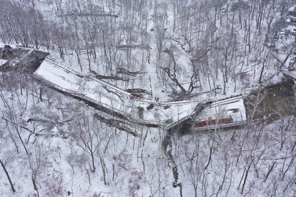Damaged vehicles are seen at the site of a collapsed bridge in Pittsburgh, Pennsylvania, U.S., January 28, 2022. Picture taken with a drone. REUTERS/Drone Base