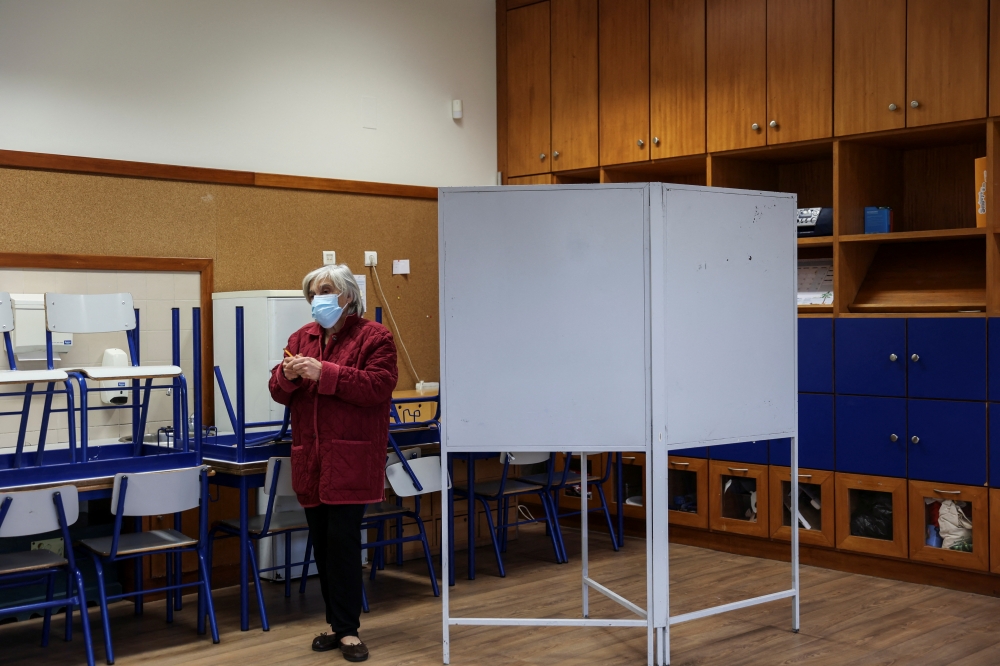 A women prepares to cast her vote at a polling station during the general election in Lisbon, Portugal, January 30, 2022. REUTERS/Rodrigo Antunes