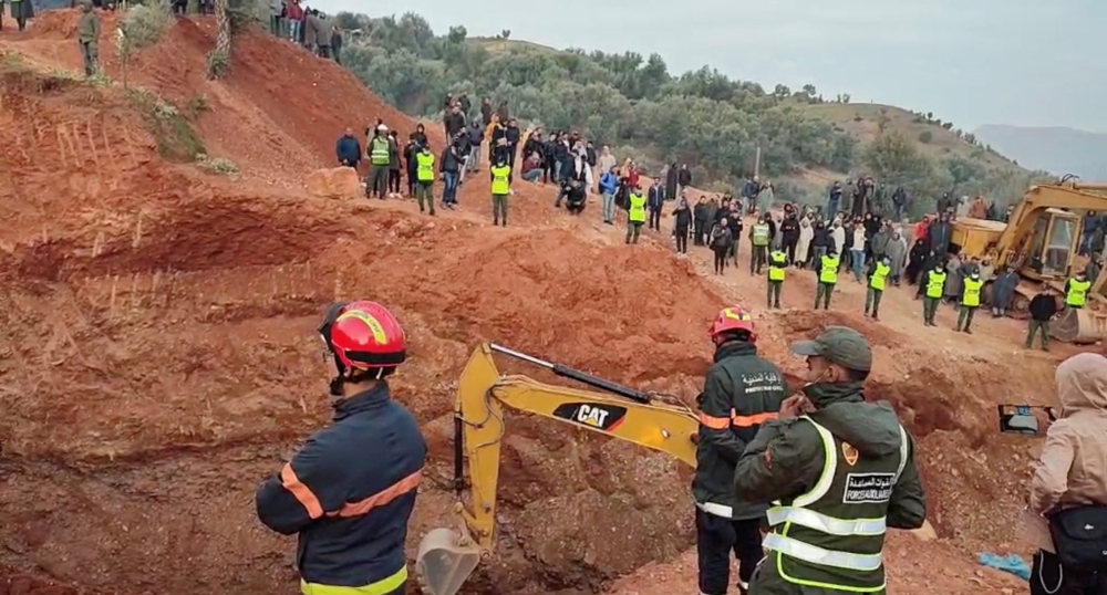 People use machinery to excavate the ground in order to free a boy trapped in an underground well, in Chefchaouen, Morocco, February 4, 2022, in this screen grab obtained from a social media video. AL3OMK.COM/via REUTERS