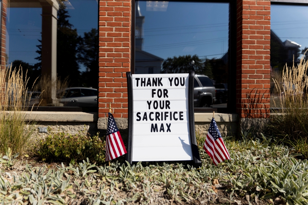 A sign placed in honor of Navy Corpsman Max Soviak, one of 13 U.S. service members killed in the airport suicide bombing in Afghanistan's capital Kabul, in his hometown of Berlin Heights, Ohio, U.S., September 8, 2021. Reuters/Megan Jelinger/File Photo