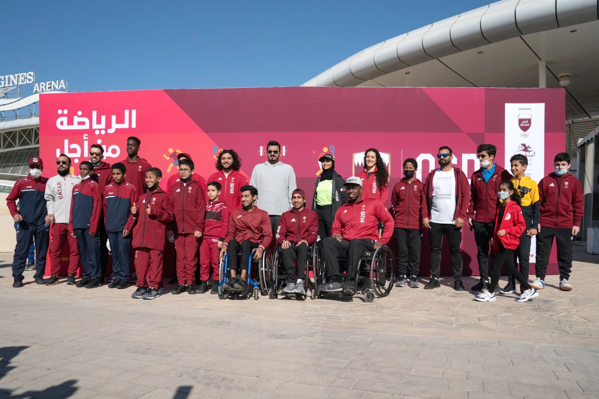 Qatar Olympic Committee (QOC) President H E Sheikh Joaan bin Hamad Al Thani poses for a photograph with QOC officials and Team Qatar athletes including country's first Olympic gold medallist Fares Ibrahim, double Paralympic medallist Abdulrahman Abdulqadir and Olympian Tala Abujbara during the National Sport Day celebrations, yesterday. 