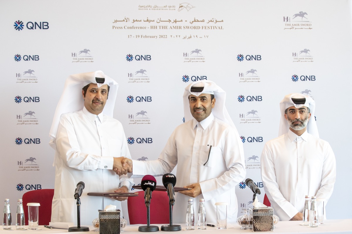 Qatar Racing and Equestrian Club Chairman Issa bin Mohammed Al Mohannadi and Salem Al Naimi, Assistant General Manager of QNB Public Relations shake hands during the sponsorship signing ceremony.   