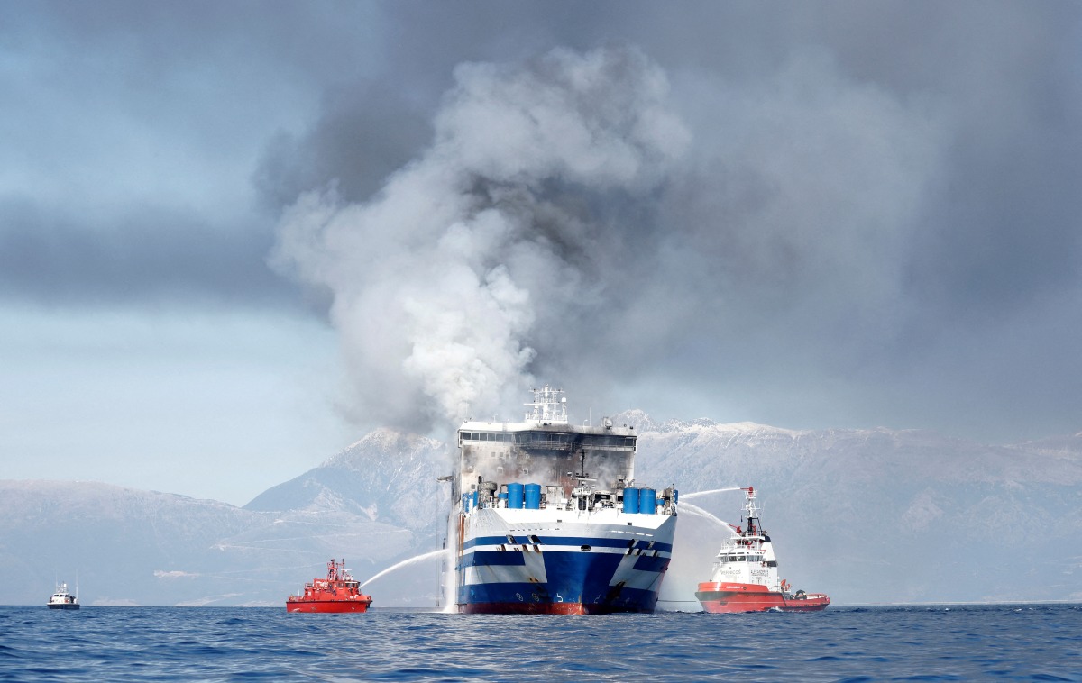 Smoke rises from the Italian-flagged Euroferry Olympia, which sailed from Greece to Italy early on Friday and caught fire, off the coast of Corfu, Greece, February 19, 2022. REUTERS/Guglielmo Mangiapane 