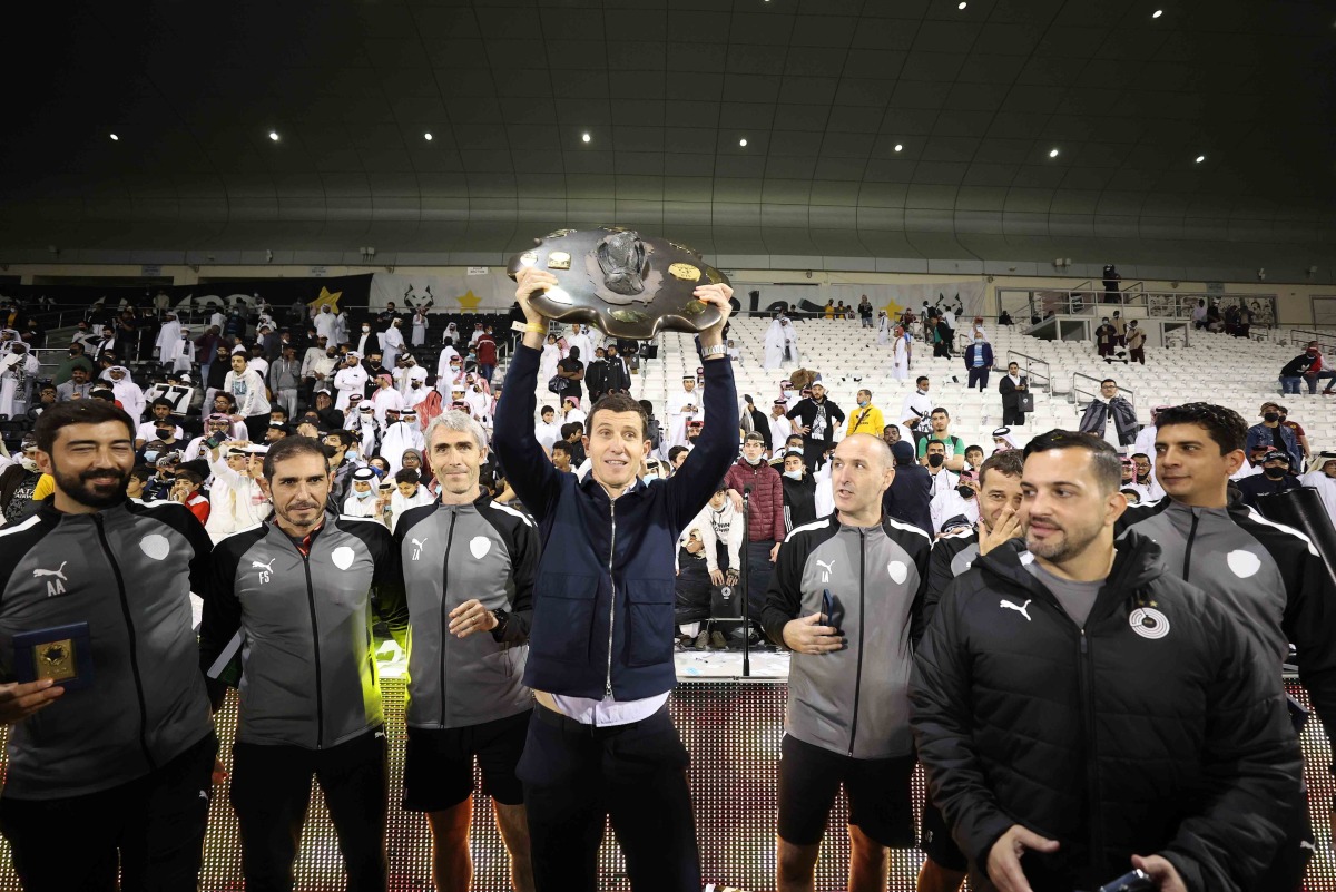 Al Sadd coach Javi Gracia celebrates with the supporting staff members. 