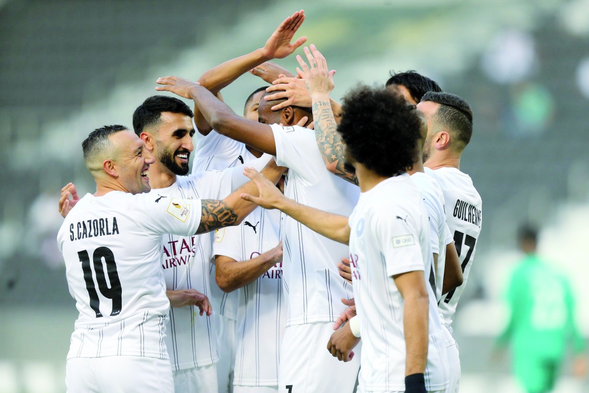 Al Sadd players celebrate after Abdelkarim Hassan scored their opening goal.