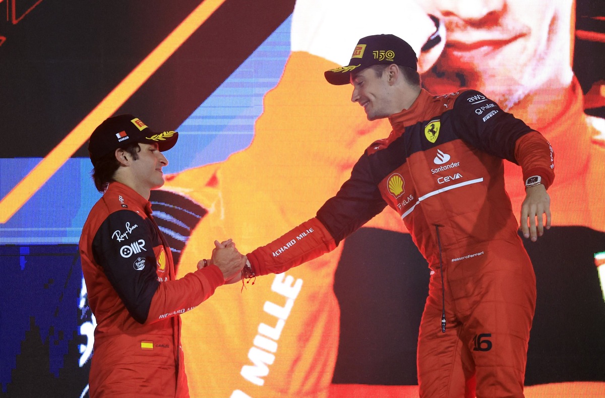 Ferrari's Charles Leclerc celebrates on the podium after winning the race with second place Ferrari's Carlos Sainz Jr. REUTERS/Thaier Al-Sudani
