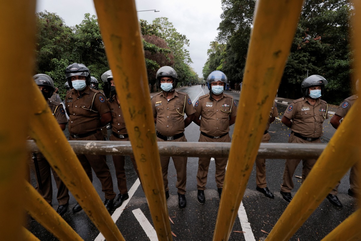 Sri Lanka police officers stand guard on a road leading to the parliament building, after the government of President Gotabaya Rajapaksa lost its majority, amid the country's economic crisis, in Colombo, Sri Lanka, April 5, 2022. REUTERS/Dinuka Liyanawatte

