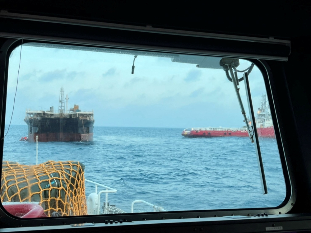 An empty vessel reported to be Kyoto 2 (L), that was towed by the missing ship on its way from the South Korean city of Busan to Indonesia's Batam port, is seen after being found near the Penghu Islands, in the Taiwan Strait, April 8, 2022. Taiwan Coastguard/Handout via REUTERS