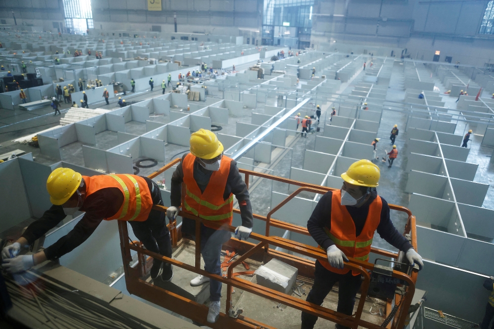 Workers labour to convert the National Exhibition and Convention Center into a makeshift hospital for the coronavirus disease (COVID-19), in Shanghai, China April 7, 2022. cnsphoto via Reuters