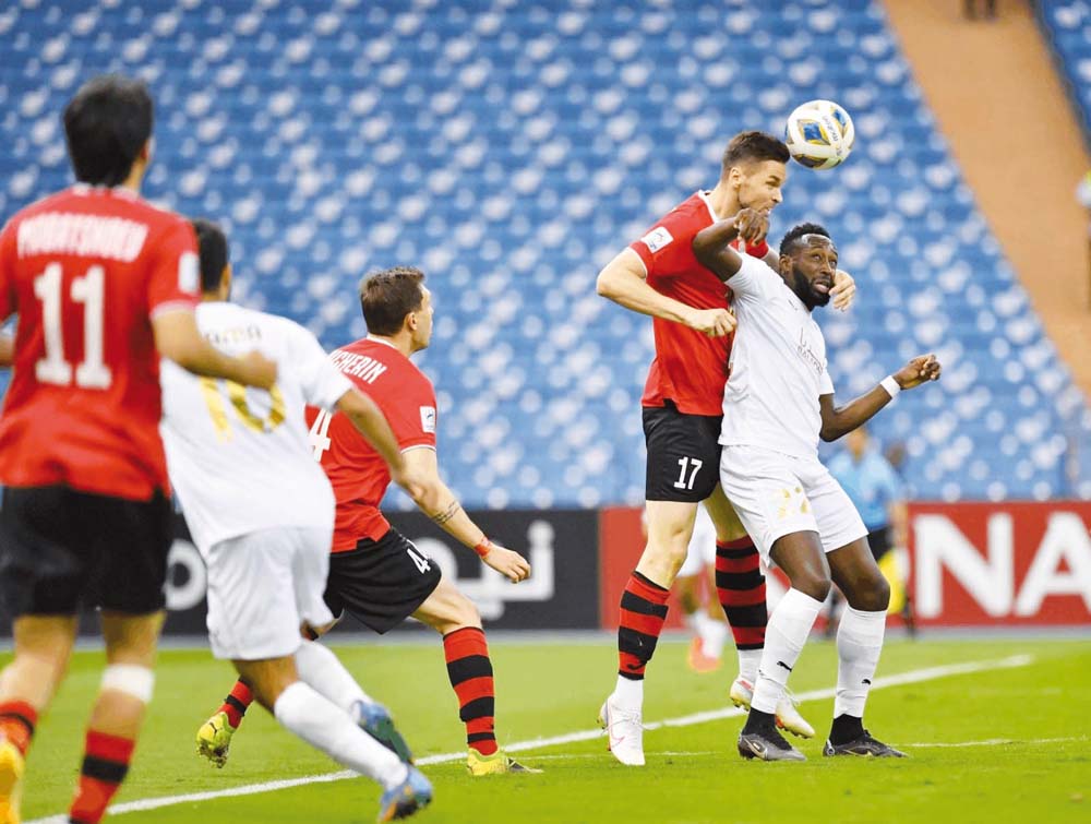 Al Rayyan’s Yohan Boli (right) and Istiklol’s Uladzislaw Kasmynin vie for the ball during the AFC Champions League group stage match in Riyadh yesterday.