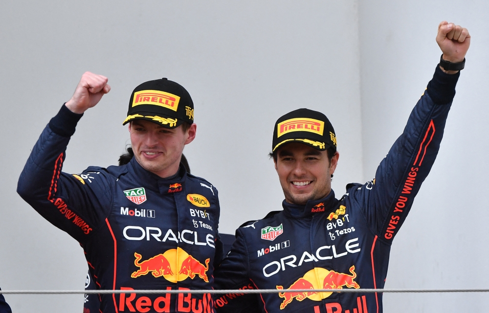 Red Bull's Max Verstappen celebrates on the podium after winning the race alongside second place Red Bull's Sergio Perez REUTERS/Jennifer Lorenzini
