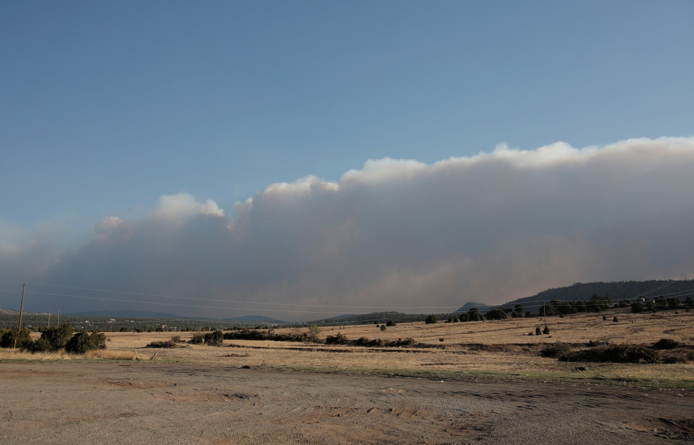 Smoke rises from the nearby Hermits Peak and Calf Canyon wildfires, in Las Vegas, New Mexico, U.S., May 2, 2022. REUTERS/Adria Malcolm