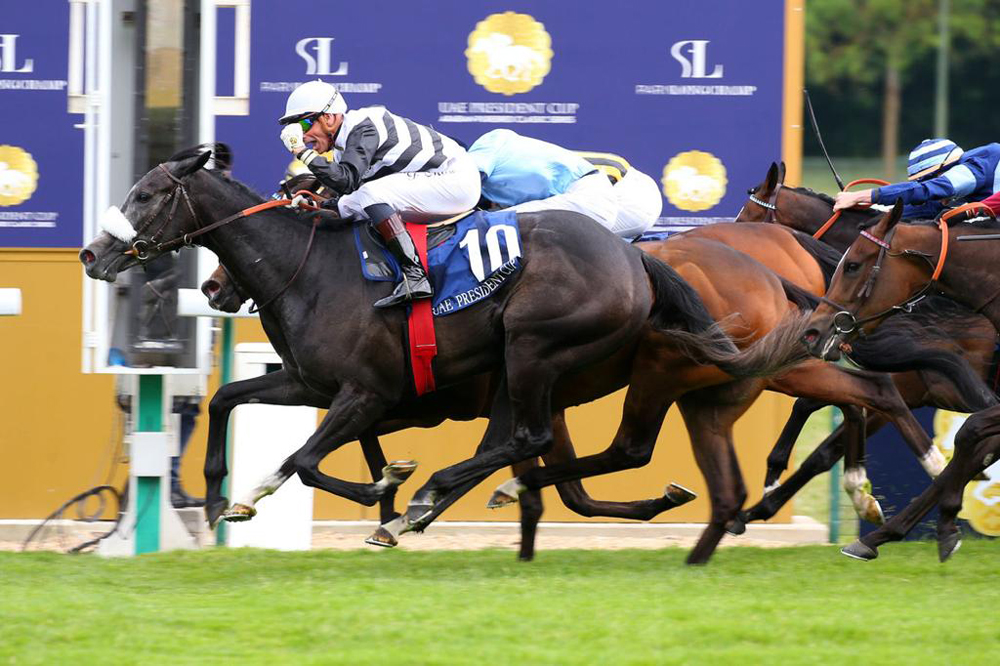 Jockey Gerald Mosse and Mangoustine cross the finish line to win Emirates Poule D'essai Des Pouliches at ParisLongchamp. 
