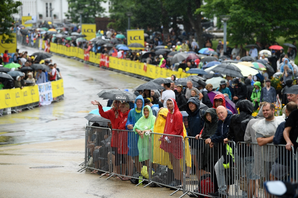 July 1, 2022 Spectators are seen with umbrellas due to rain before the stage 1 REUTERS/Annegret Hilse