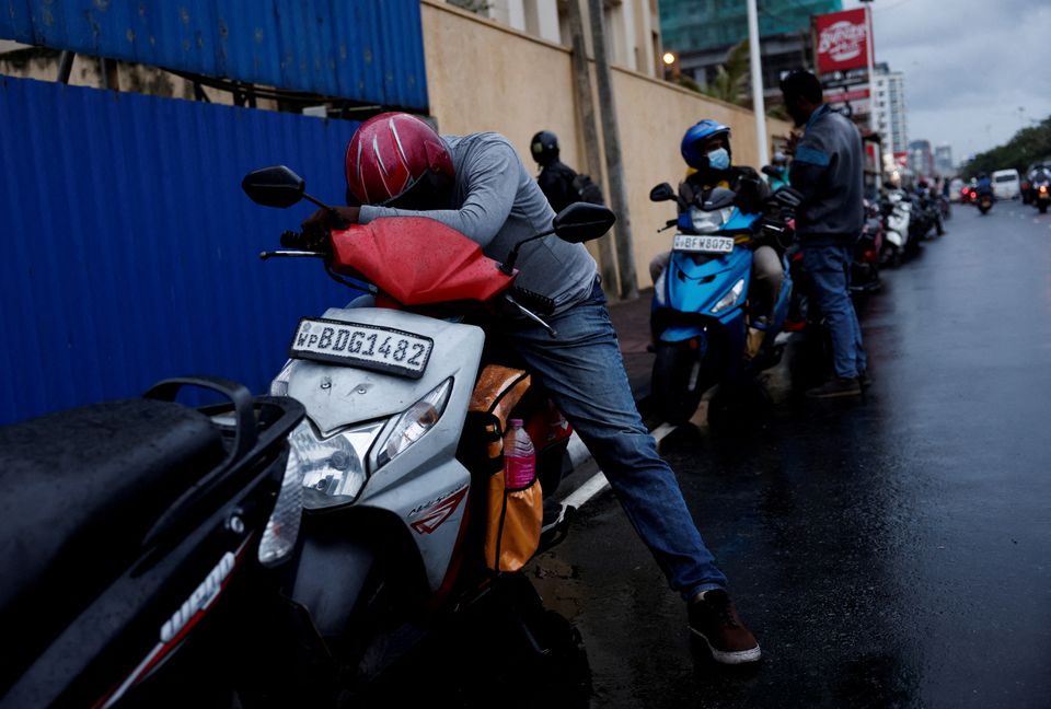 A man waits in a queue to buy petrol due to fuel shortage, amid the country's economic crisis, in Colombo, Sri Lanka, June 16, 2022. REUTERS/Dinuka Liyanawatte/File Photo

