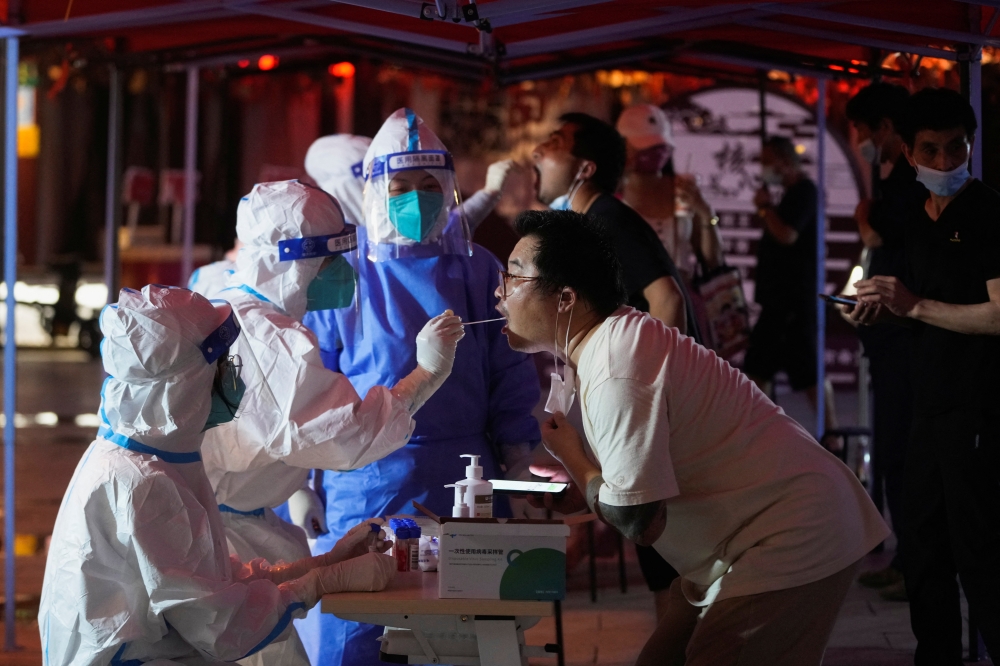 A man gets tested for the coronavirus disease (COVID-19) at a nucleic acid testing site, following the coronavirus disease (COVID-19) outbreak, in Shanghai, China July 12, 2022. REUTERS/Aly Song