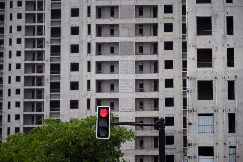 A traffic light is seen near a construction site of residential buildings in Shanghai, China July 20, 2022. REUTERS/Aly Song