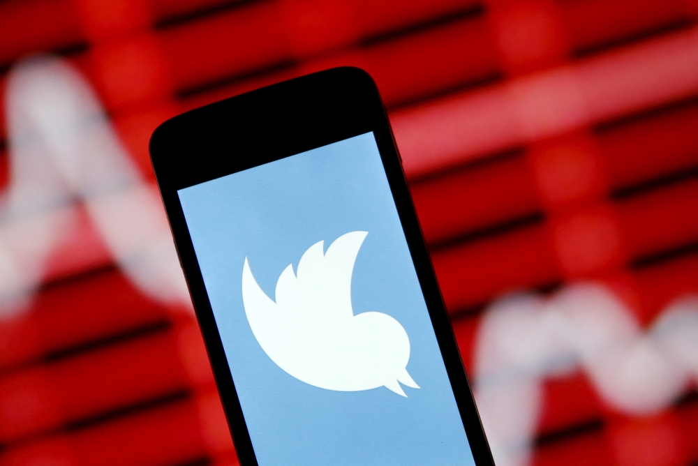 The Twitter logo is shown on a smartphone in front of a displayed stock graph in this April 29, 2015 photo illustration. (REUTERS/Dado Ruvic)