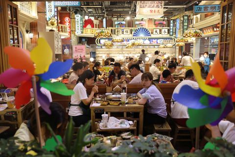 Customers dine at a restaurant in a shopping area in Beijing, China July 25, 2022. REUTERS/Tingshu Wang