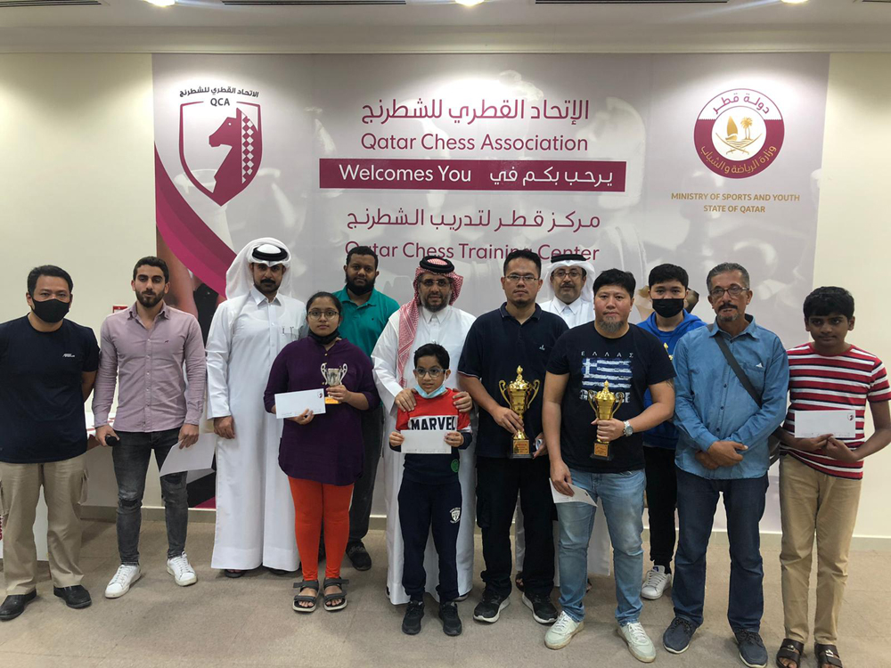 The trophy winners of the Open Blitz Chess Championship pose for a photograph with the officials.