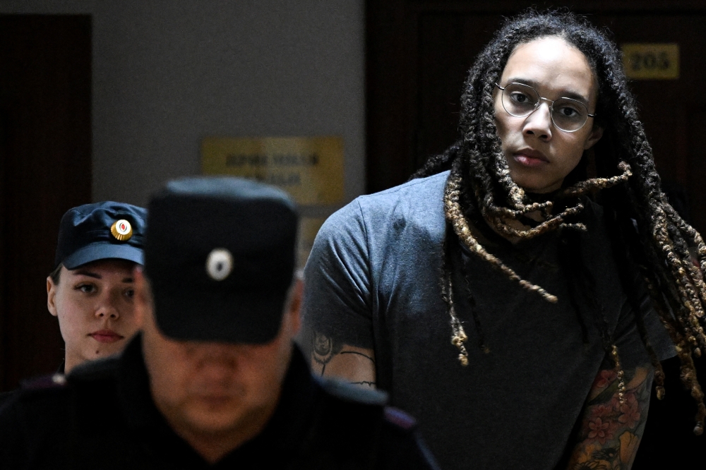 US basketball player Brittney Griner is escorted in a court building in Khimki outside Moscow, Russi, August 4, 2022. (Kirill Kudryavtsev/Pool via REUTERS)
