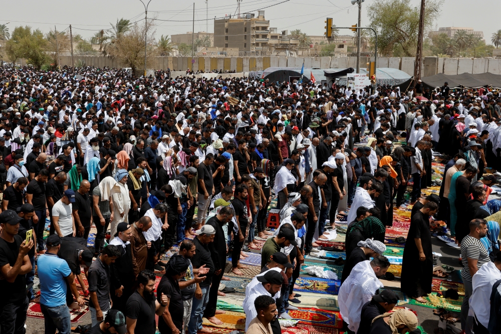 Supporters of Iraqi populist leader Moqtada al-Sadr gather for a Friday prayer in front of the parliament near the Green Zone, in Baghdad, Iraq, August 12, 2022. (REUTERS/Ahmed Saad)
