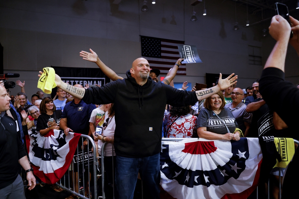 Democratic U.S. Senate candidate John Fetterman poses for a photograph with a supporters during a rally in Erie, Pennsylvania, U.S., August 12, 2022. (REUTERS/Quinn Glabicki)