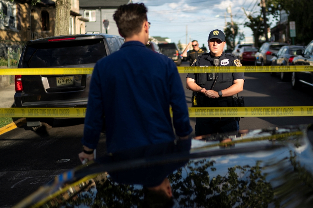 New Jersey Police officers stand guard near the building where alleged attacker of Salman Rushdie, Hadi Matar, lives in Fairview, New Jersey, US, August 12, 2022. (REUTERS/Eduardo Munoz)
